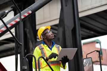 engineer man / worker in safety jumpsuit uniform with yellow hardhat and use laptop computer...