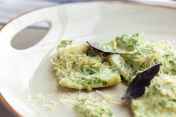 Russian dumpling served with parsley and cheese on plate