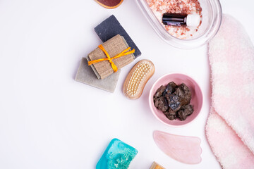 Obraz na płótnie Canvas natural spa set with salt, healing mud and soap on white background. flay lay