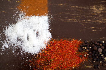 Various spices and seeds on a dark background. Background texture spices with copy space.