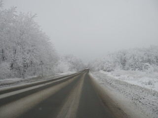 Obraz na płótnie Canvas Empty snow covered road in winter landscape