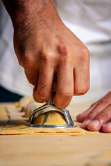 Process of making ravioli. Chefs hands using ravioli form..Front view..Italian concept food.