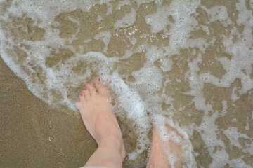 Barefoot in the water by the sea