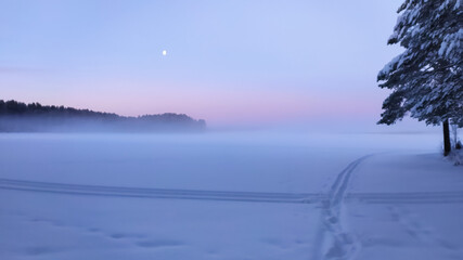 Russia, Karelia, Kostomuksha. The sun rises over the lake on a winter day.January 04, 2021.