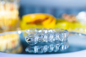 Invisible aligners teeth retainers lie on the mirror