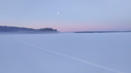 Russia, Karelia, Kostomuksha.Morning fog stands over the lake on a frosty day.January 04, 2021.
