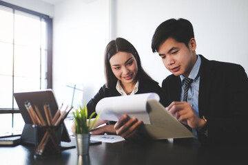 Two business people working on their new project in modern office.