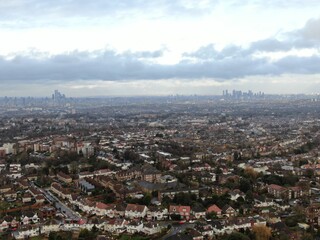 Aerial view above Streatham, London, United Kingdom with the downtown cityscape of london at the horizon