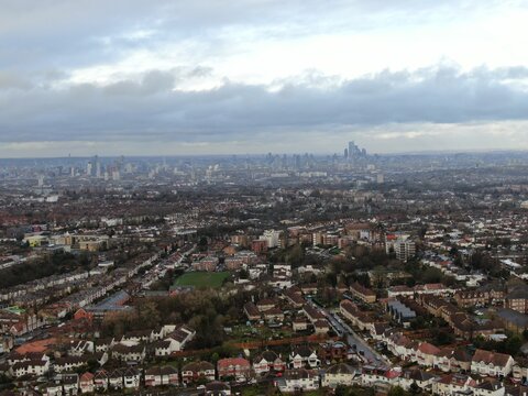 Aerial view above Streatham, London, United Kingdom with the downtown cityscape of london at the horizon