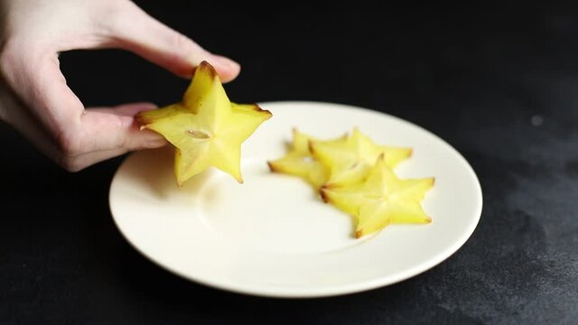 fresh carambola star fruit cut into slices ready to cook and eat on the table for healthy meal snack outdoor top view copy space for text food background rustic image keto or paleo diet