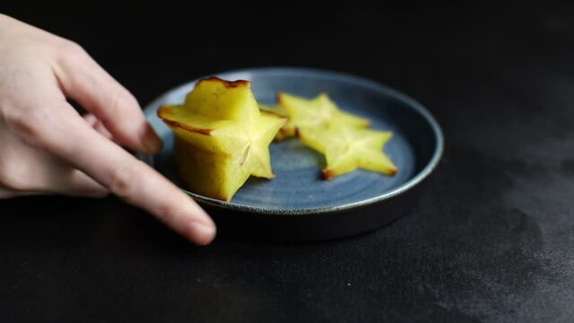 fresh carambola star fruit cut into slices ready to cook and eat on the table for healthy meal snack outdoor top view copy space for text food background rustic image keto or paleo diet