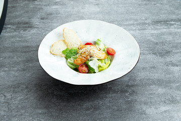 Salad with herbs and chicken in a plate