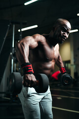 Fototapeta na wymiar African american man is engaged in the gym performing strength training to build arm muscles
