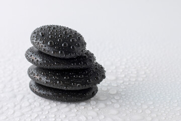 Fototapeta na wymiar stacked black stones on white background