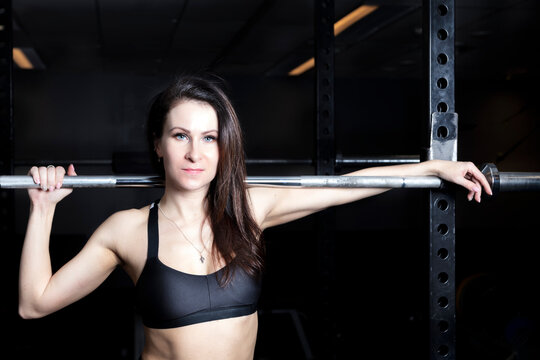 In the gym a brunette in sportswear.
She poses
Photo after filter processing