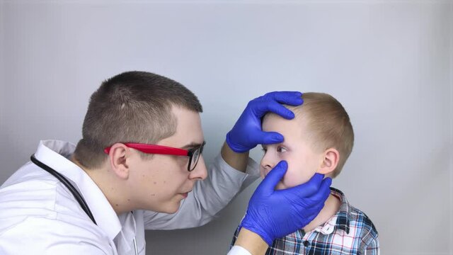 An ophthalmologist examines a boy who complains of burning and pain in his eyes. Eye fatigue from a computer or phone screen (sensation of sand on the cornea). Diagnosis of conjunctivitis in children.