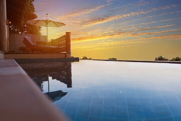 Exotic romantic sunset beatiful pool villa resort. Infinity pool with amazing sunset sky. Pool villa with beatiful pomantic view.