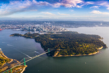 Naklejka premium Beautiful Aerial View of Lions Gate Bridge, Stanley Park and Vancouver Downtown, British Columbia, Canada. Colorful Sunrise Artistic Render
