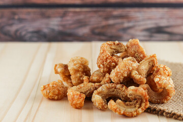 Close-up Pork snack or Pork scratching leather lean pork fried crispy and blistered on wooden background.