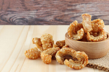 Close-up Pork snack or Pork scratching leather lean pork fried crispy and blistered on wooden background.