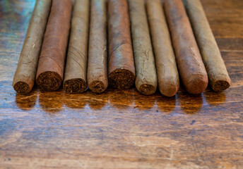 Cuban cigars variety on wooden office desk, closeup view