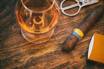 Cuban cigar and whiskey on wooden desk