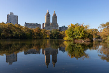 Fototapeta na wymiar The Lake at Central Park during Autumn with the Upper West Side Skyline Reflection and Colorful Trees in New York City