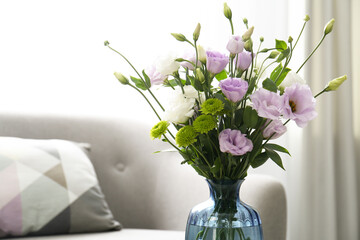 Naklejka na ściany i meble Bouquet of beautiful Eustoma flowers in room, closeup. Space for text