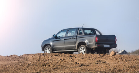 Fototapeta na wymiar Pickup truck moves on a dirt road