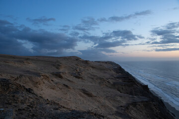 Fototapeta na wymiar Sand dunes during the blue hour on the coast of Denmark...