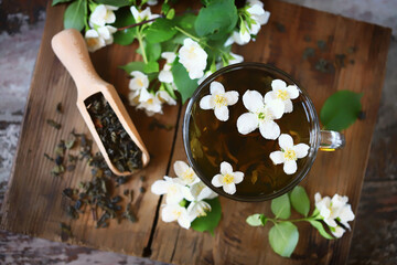 Selective focus. Fresh jasmine tea in a cup with jasmine flowers.