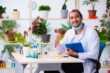 Young male chemist perfumer working in the lab