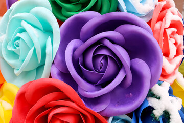 Fototapeta na wymiar Artificial beautiful colorful roses in the snow