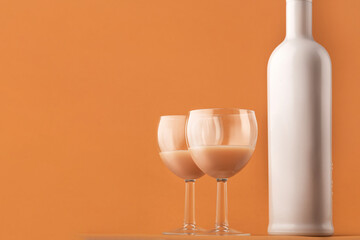 coffee liqueur. A white milk-colored bottle and two glasses with a coffee cocktail, copy space