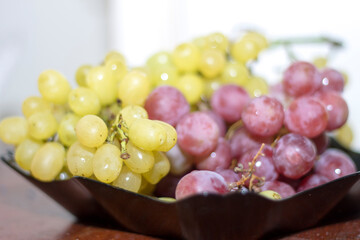 Red and White wine bunch of grapes in the black plate