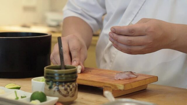Sushi chefs making sushi to serve customers at omakase restaurant.