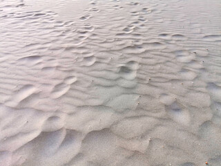 human footprints on the beach sand.