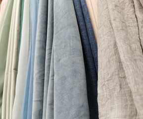 Detailed close up view on samples of cloth and fabrics in different colors found at a fabrics...