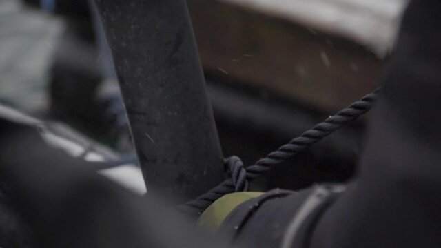 Securely gripping anchor rope for boats in extreme winter closeup