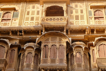 Beautiful details carved facade wall and windows exterior architecture in Patwon Ki Haveli in Jaisalmer, rajasthan India. This is Famous Haveli Architecture in Rajasthan.