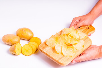 Organic potato on Wooden cutting board with isolated white background, Close up raw nature vegetable