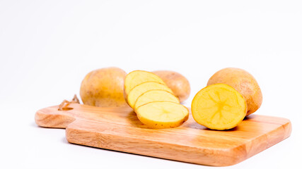 Organic potato on Wooden cutting board with isolated white background, Close up raw nature vegetable