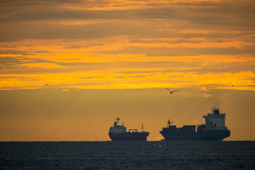 Fototapeta premium Logistics import export Container Cargo ship in seaport on sunset sky, Freight Transportation by container ship boat