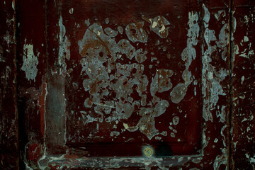 Abstract background pattern of scraped damaged paint with gouges on a wooden door in close up in a full frame view
