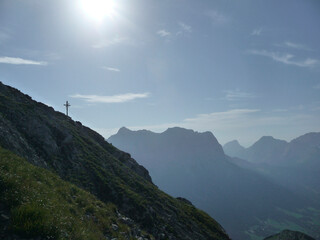 Summit cross Upsspitze and Daniel mountain at Ammergau Alps, Tyrol, Austria