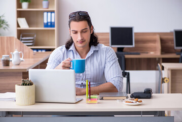 Young male businessman employee working in the office