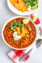 Mexican Chilli with Minced Meat Garnished with Savory Cream, Lemon and Cimantro Vertical Photo