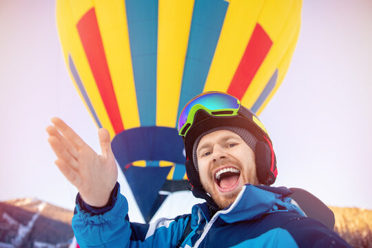 Walking In Hot Air Balloon In Winter, Young Man Takes Selfie Photo In Clothes Of Skier