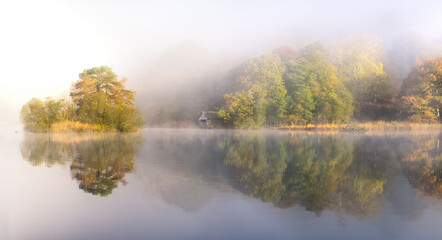 Misty Morning beside Rydal Water in the Lake District, looking towards a quaint boathouse