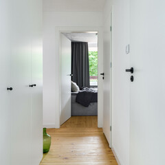 Small white corridor with wooden floor